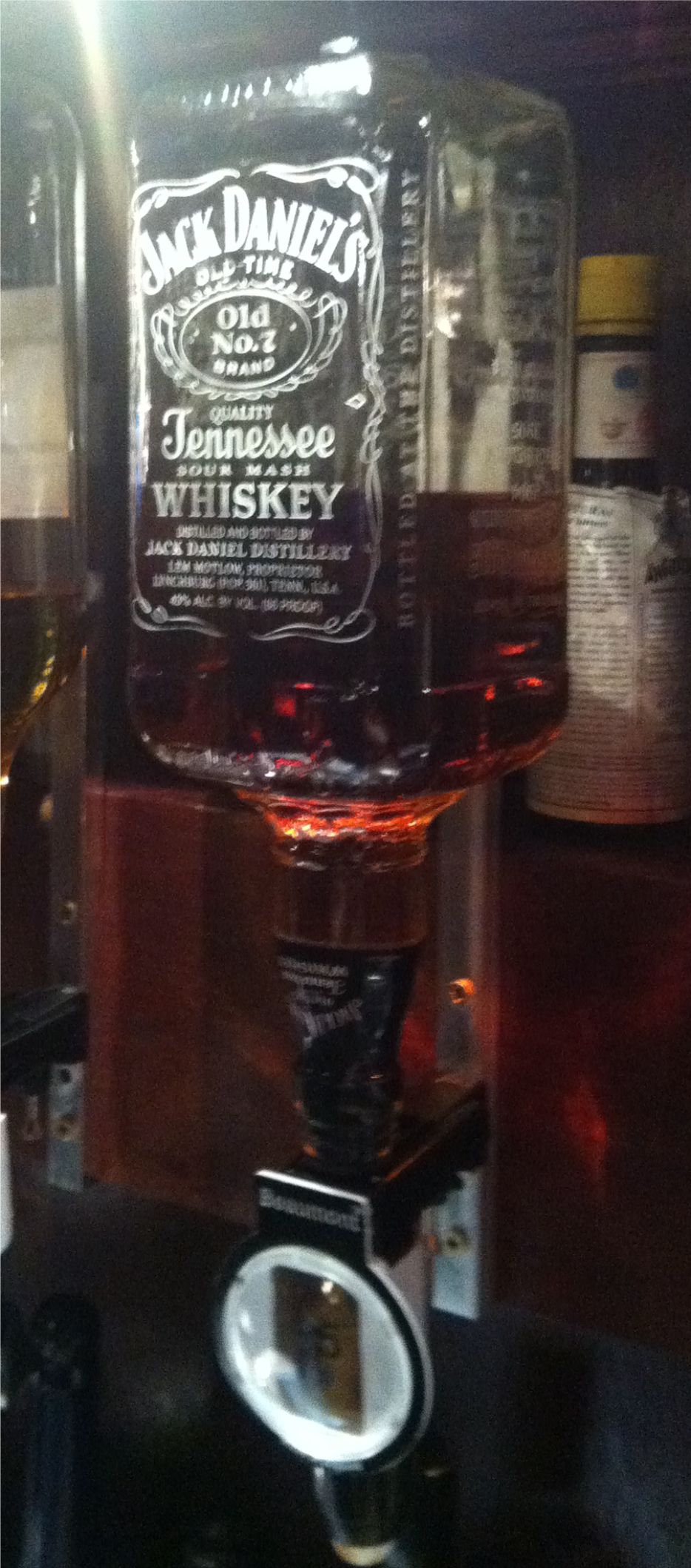 An optic bottle engraved with the label of Jack Daniels.