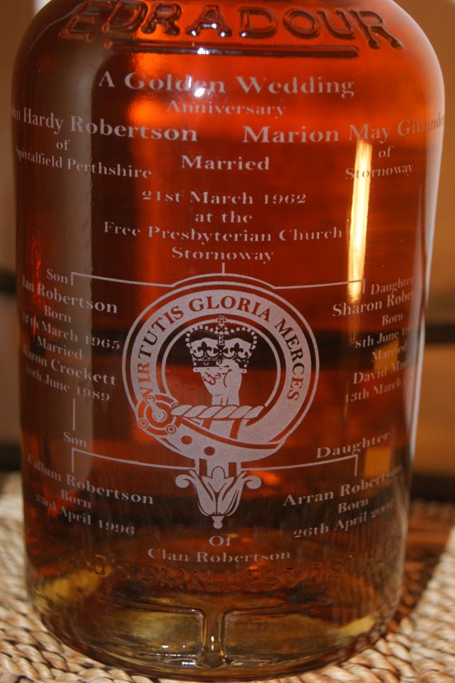 A Bottle of whisky engraved with a Clan Robertson Badge and the Family Tree of a couple celebrating their Golden Wedding Anniversary.