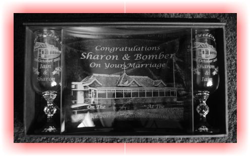 This is a piece of Curved Glass and two matching Champagne Flutes. The curved Glass is engraved with the photograph of the Irvine Winton Bowling Club club house, the name of the bride and groom and the details of the wedding. The wine glasses are engrave with the same , however one glass has the brides name first and the second has the grooms name first.