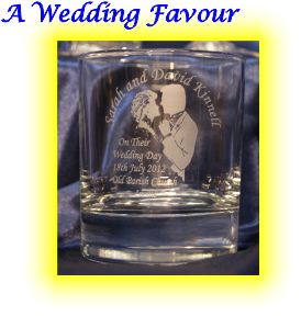 This is a plain whisky glass engraved with a bride and groom. It also has engraved onto the their name and details of the ceramony. These engraved glasses were given to male guests at the wedding reception.