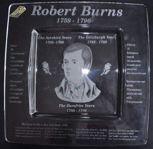 This is a square crystal plate engraved with a photograph of Robert Burns in the center and some of his poetry engraved around the edges. These depict his Ayrshire years, Edinburgh years and his Dumfries years.