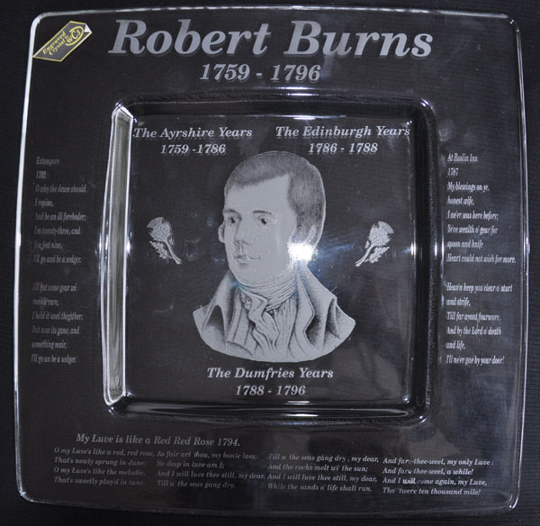 This is a square crystal plate engraved with a photograph of Robert Burns in the center and some of his poetry engraved around the edges. These depict his Ayrshire years, Edinburgh years and his Dumfries years.