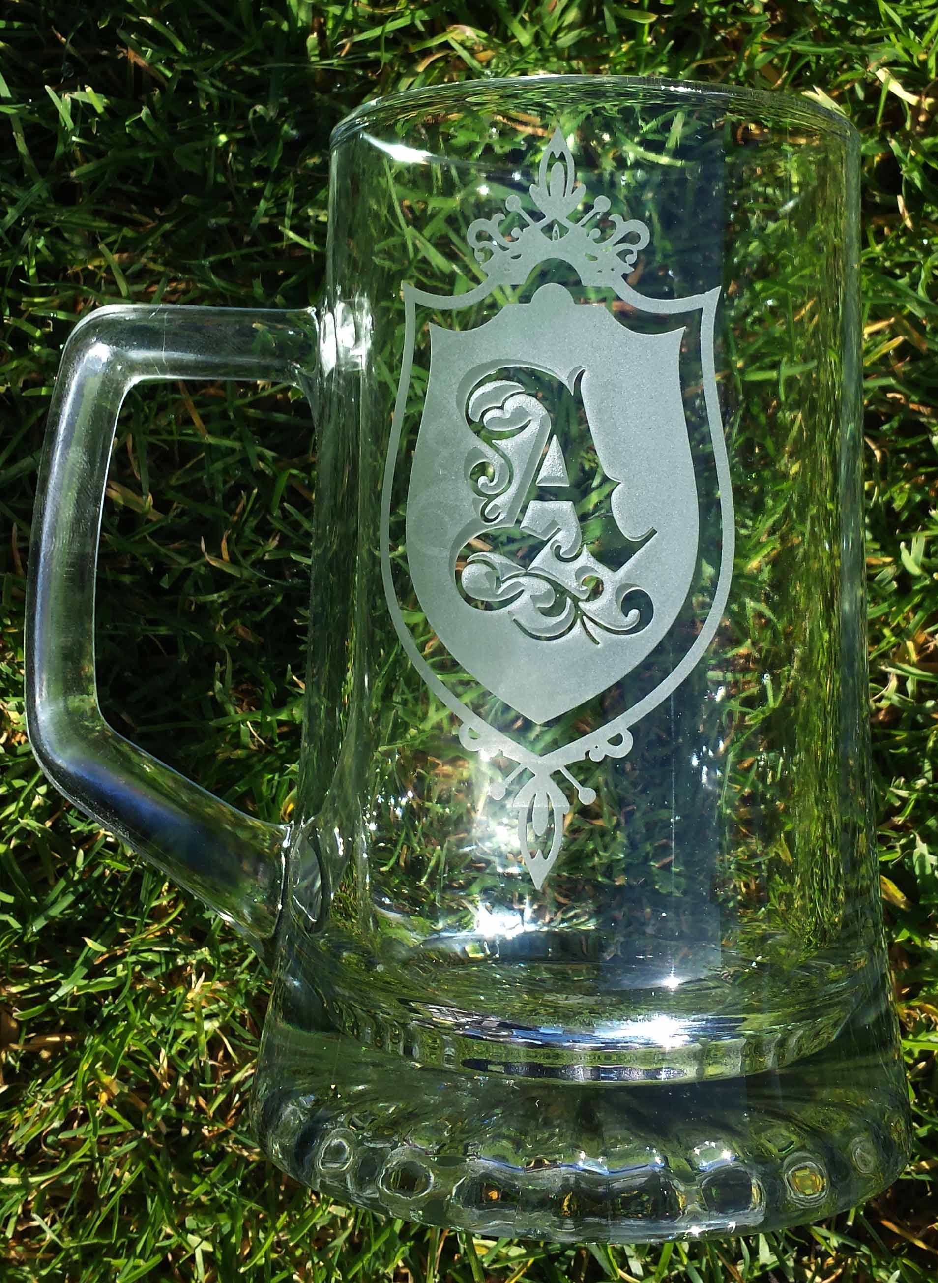 This is a pint glass engraved very deeply around a monogrammed A giving the A the look of being high above the surface of the Glass.
